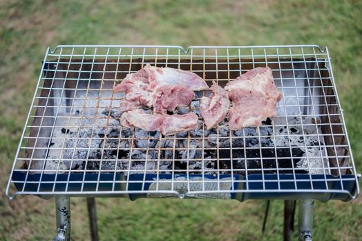 meat being grilled outdoors