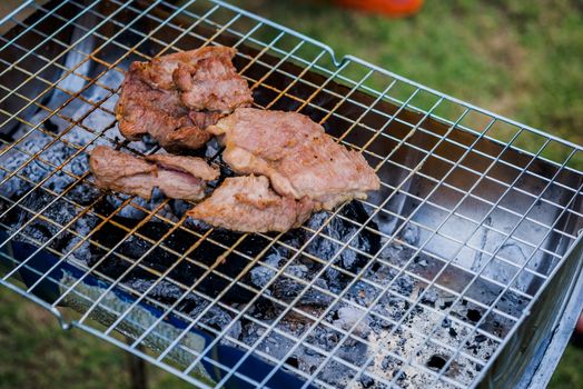 meat being grilled outdoors