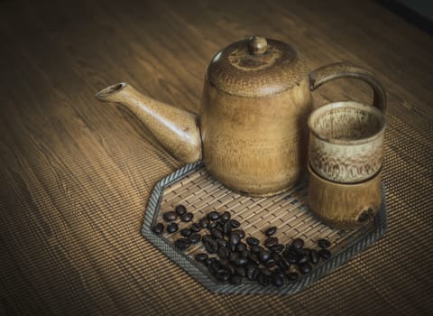 Vintage photo of coffee beans and Coffee cups set on wooden background.Vintage style.