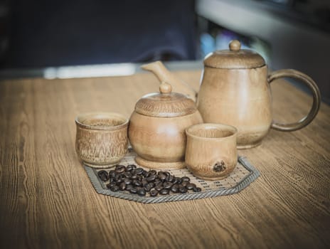 Vintage photo of coffee beans and Coffee cups set on wooden background.Vintage style.