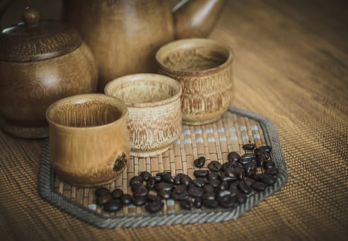 Vintage photo of coffee beans and Coffee cups set on wooden background.Vintage style.