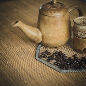 Vintage photo of coffee beans and Coffee cups set on wooden background.Vintage style.