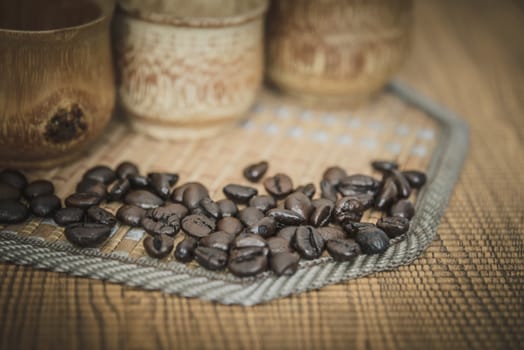 Vintage photo of coffee beans and Coffee cups set on wooden background.Vintage style.