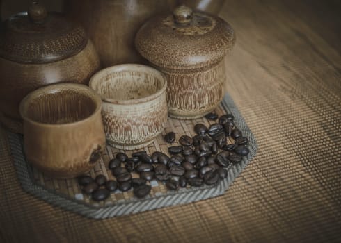 Vintage photo of coffee beans and Coffee cups set on wooden background.Vintage style.