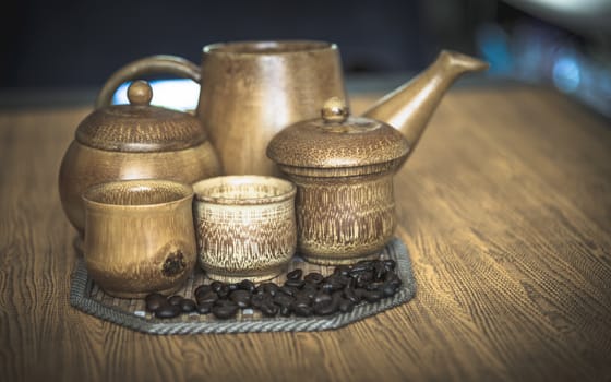 Vintage photo of coffee beans and Coffee cups set on wooden background.Vintage style.