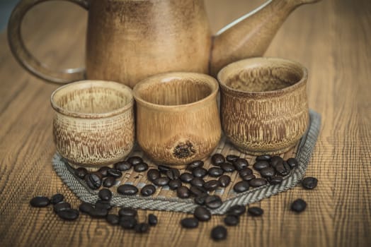 Vintage photo of coffee beans and Coffee cups set on wooden background.Vintage style.