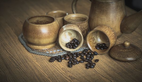 Vintage photo of coffee beans and Coffee cups set on wooden background.Vintage style.