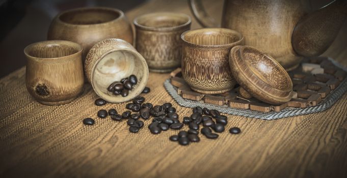 Vintage photo of coffee beans and Coffee cups set on wooden background.Vintage style.