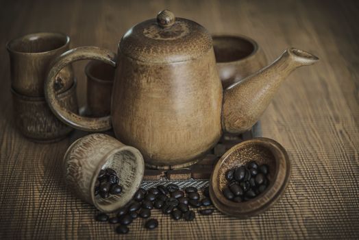 Vintage photo of coffee beans and Coffee cups set on wooden background.Vintage style.