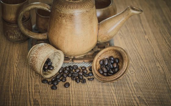 Vintage photo of coffee beans and Coffee cups set on wooden background.Vintage style.