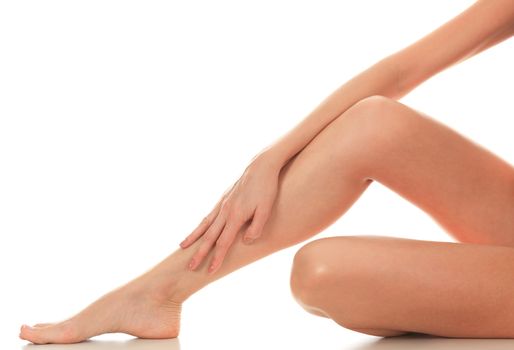 Female legs and hands, white background, isolated