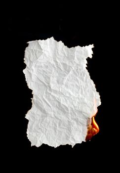 white crumpled  paper burning on black background