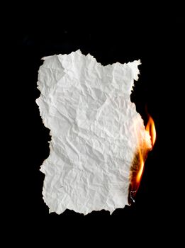 white crumpled  paper burning on black background