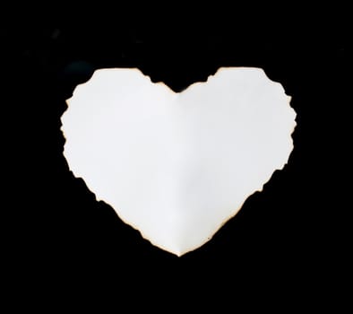 white heart shape paper on black background