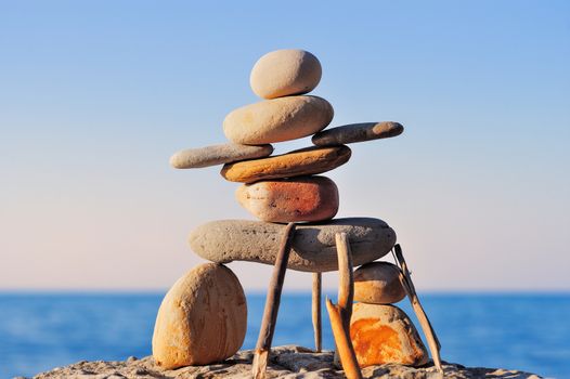 Figure of inukshuk on the sea boulder