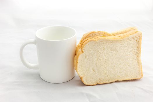 Empty coffee cup or coffee mug and sliced bread isolated on white background.