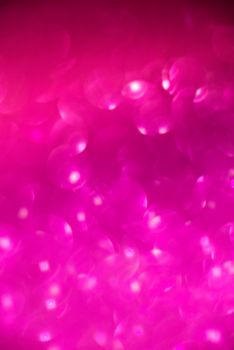 Abstract background of pink holiday lights with copy space.