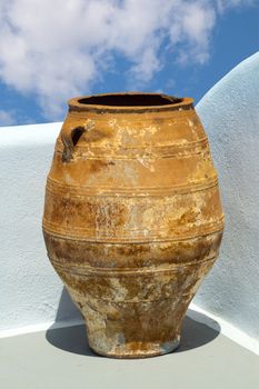 Greek amphora under blue sky on traditional balcony