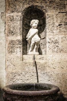 Image of small fountain with angel statue in Bavaria town Landsberg am Lech in Germany