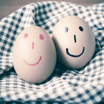 smile love egg couple in brown kitchen towel on wood table vintage style
