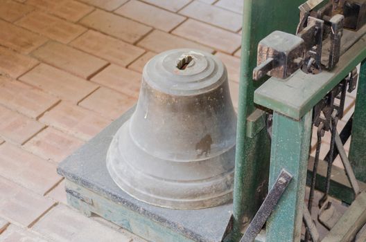 Bell is weighed on an old antique decimal scale.