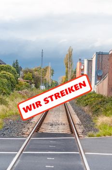 Railway strike, empty tracks. Seemingly endless railway tracks with a protest sign. With labeling, strike.