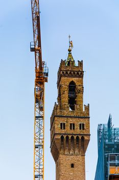 the famous tower of Palazzo Vecchio near to a crane scaffolds