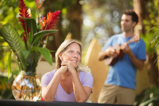 Pretty mature female listening to performer on vacation