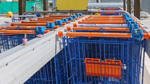 colored shopping carts in row