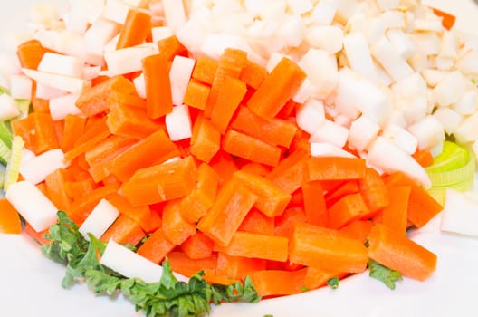 Various types of vegetables cut in front of white background