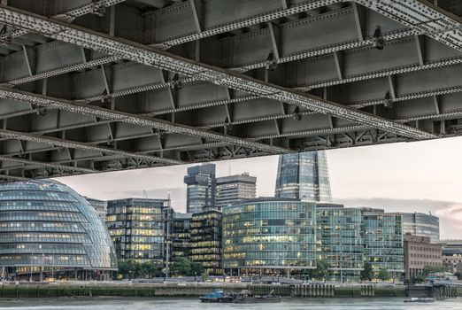 London riverside skyline from underneath Tower Bridge.