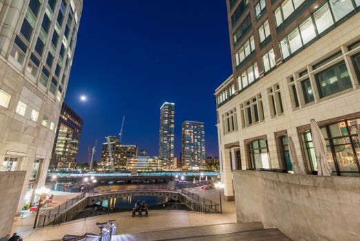 Beautiful Canary Wharf skyline at night, London from street level.