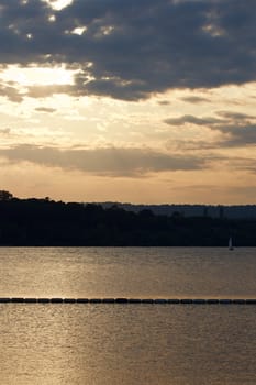 Beautiful sunset on the lake with the yacht