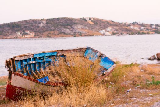 View of an old rusty boat out of the water.