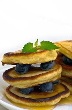 Delicious pancakes close up, with fresh blueberries and maple sy