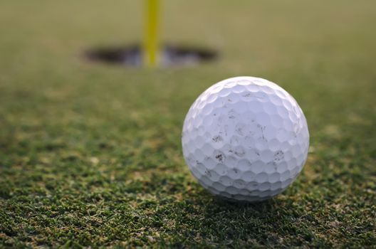 Golf Ball close to hole