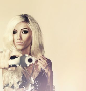 Beautiful blond woman holding gun