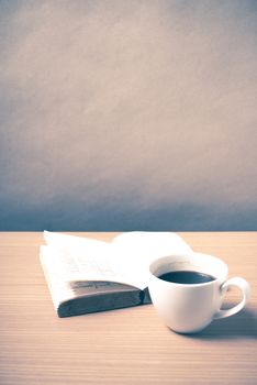 open book with coffee on wood background vintage style