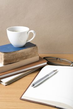 open book with coffee cup on wood background