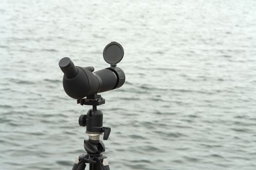 Nature birdwatching spotting scope monocular on a tripod near the water great outdoors activity                              