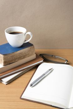 open book with coffee cup on wood background