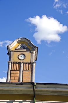 tower with ancient clock on old manor roof and sky with cloud