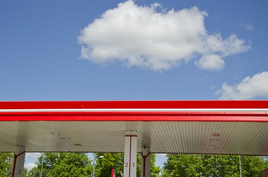 modern colorful gasoline fuel station roof and clouds