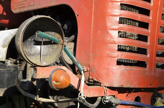 old vintage used red tractor fragment with lamp