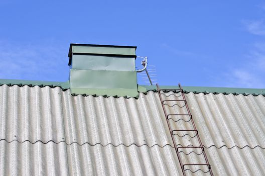 new house roof with chimney and ladder on ecological slate