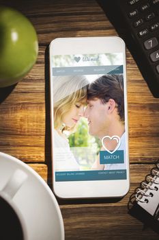 Dating website against smartphone on desk