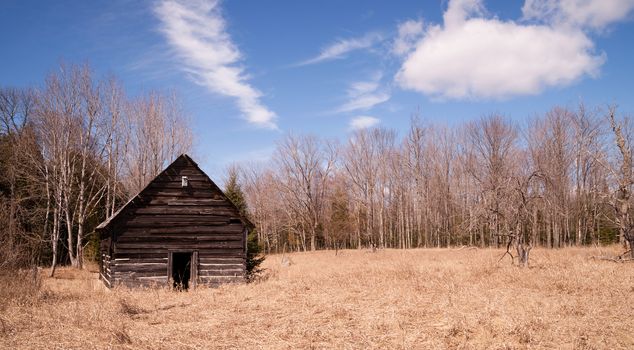 An abandoned cabin stands still after occupants are long gone