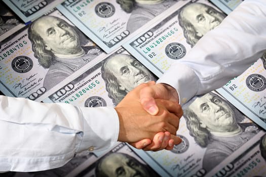 Handshake and Dollars Banknotes Background