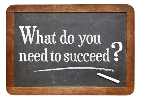 What do you need to succeed?  A question on a vintage slate blackboard, A success concept.