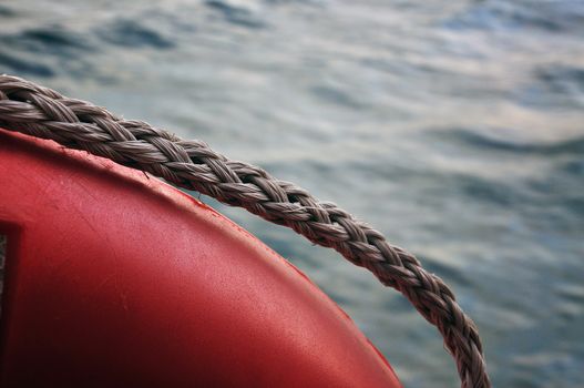 Red life buoy on sea background photographed from a boat